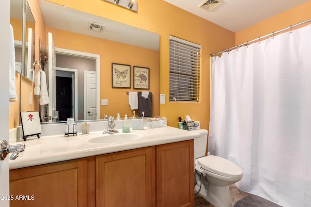 bathroom featuring toilet, a shower with shower curtain, vanity, and visible vents