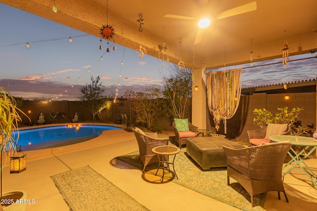 pool at dusk featuring a patio area, a fenced backyard, outdoor lounge area, and a fenced in pool