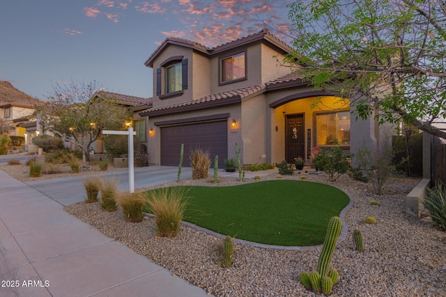 mediterranean / spanish home with a garage, a tile roof, driveway, and stucco siding