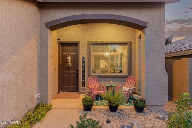 view of exterior entry with stucco siding