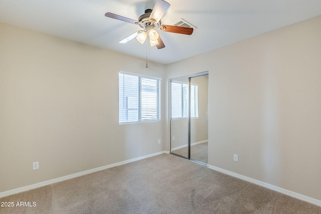 43205 W Oster Dr, Maricopa, AZ 85138 - unfurnished bedroom featuring carpet, a closet, baseboards, and a ceiling fan