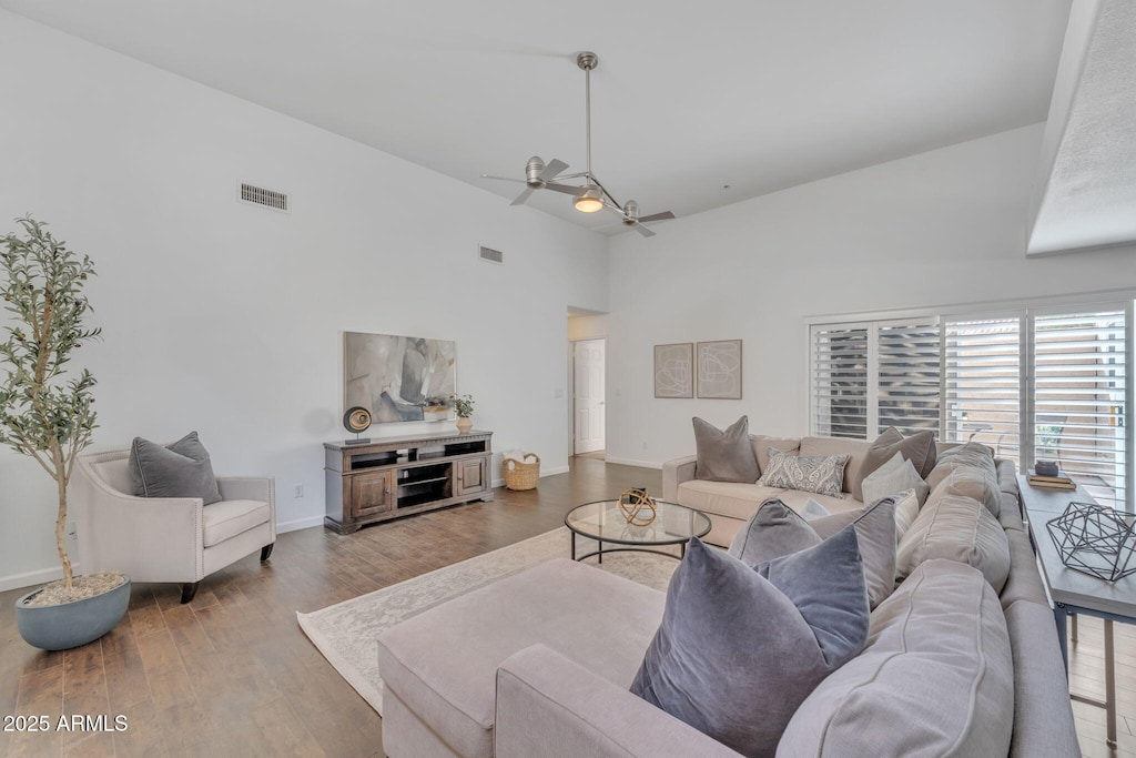 living room featuring hardwood / wood-style flooring, ceiling fan, and high vaulted ceiling