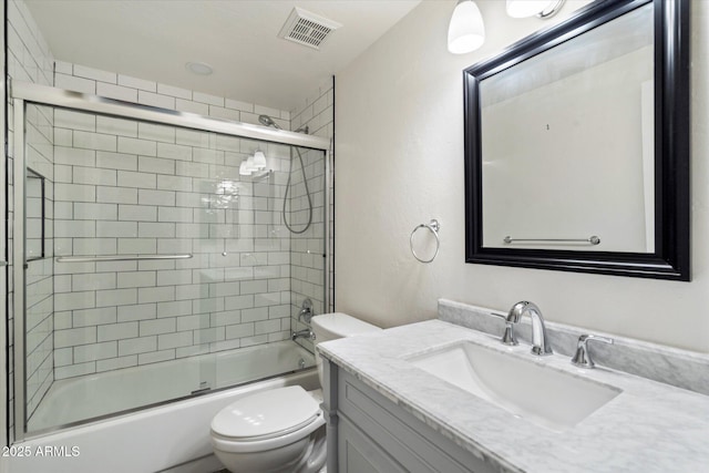 full bathroom with vanity, toilet, and bath / shower combo with glass door