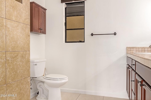 bathroom with tile patterned flooring, vanity, and toilet