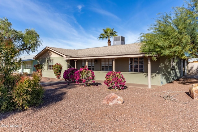 ranch-style house with roof with shingles and stucco siding