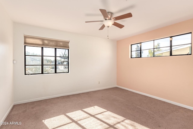 unfurnished room with carpet, ceiling fan, and a wealth of natural light