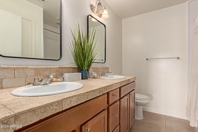 bathroom featuring tile patterned flooring, vanity, toilet, and backsplash