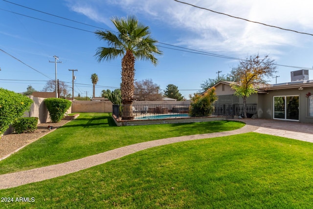 view of yard with a fenced in pool