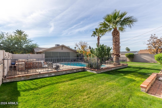 view of yard with a patio and a fenced in pool