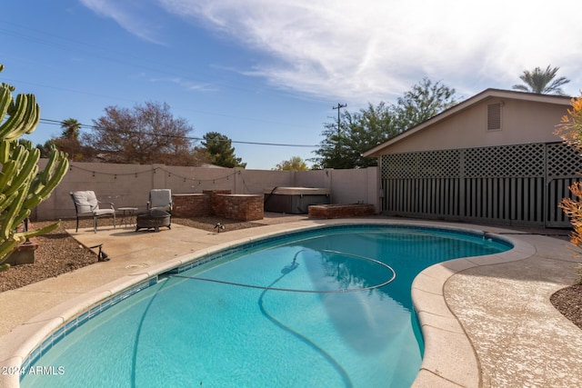 view of pool featuring a hot tub and a patio area