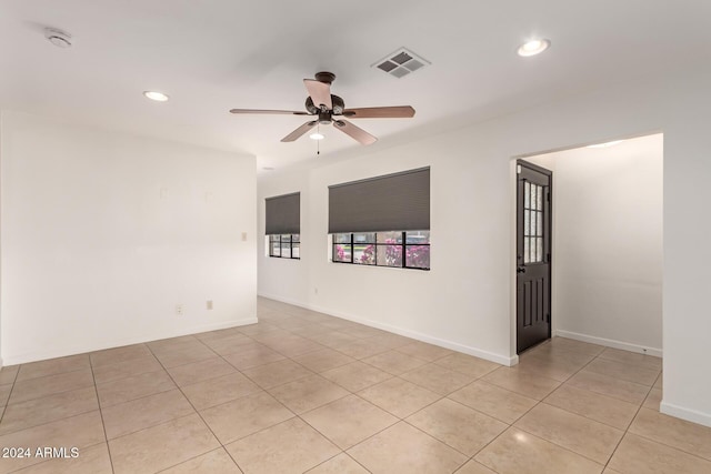 unfurnished room featuring light tile patterned floors and ceiling fan