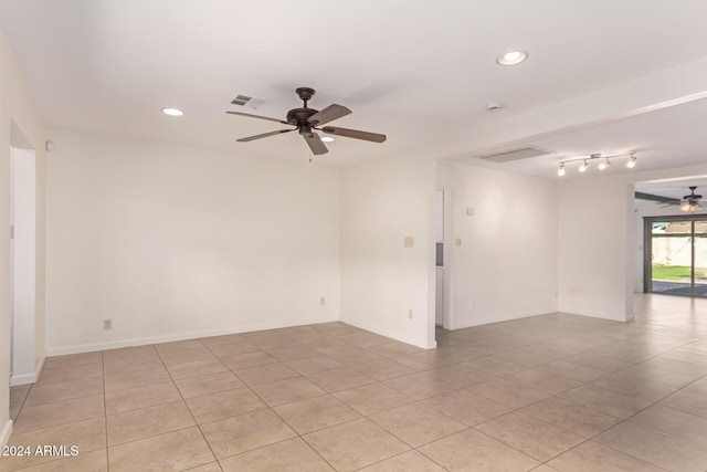 tiled spare room with ceiling fan