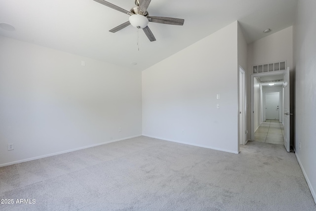 unfurnished bedroom featuring baseboards, ceiling fan, visible vents, and light carpet