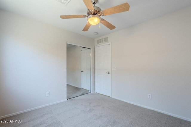 unfurnished bedroom with carpet floors, baseboards, visible vents, and a closet