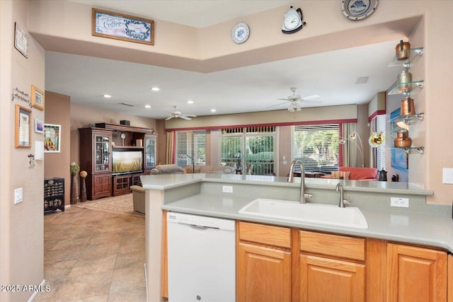 kitchen with sink, white dishwasher, ceiling fan, and kitchen peninsula