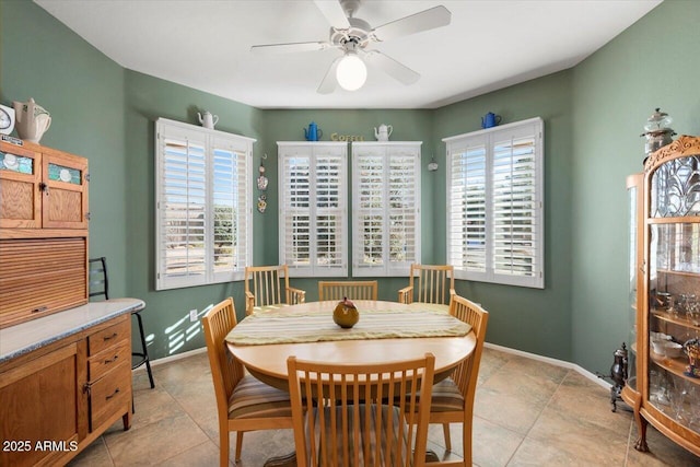 dining space with light tile patterned flooring, ceiling fan, and plenty of natural light