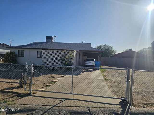 4426 S 36th Dr, Phoenix, AZ 85041 - ranch-style home featuring fence, a gate, a shingled roof, and driveway