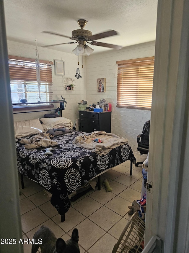 4426 S 36th Dr, Phoenix, AZ 85041 - tiled bedroom with a ceiling fan, a textured ceiling, and multiple windows