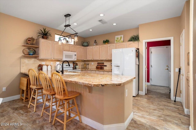 kitchen with kitchen peninsula, light brown cabinetry, backsplash, and white appliances