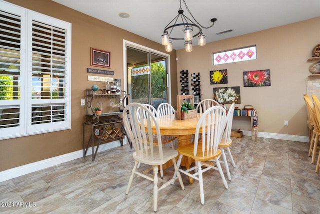 dining area featuring an inviting chandelier