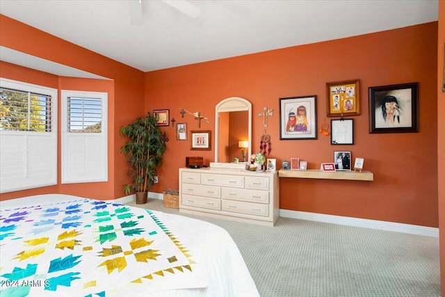 bedroom featuring ceiling fan and carpet