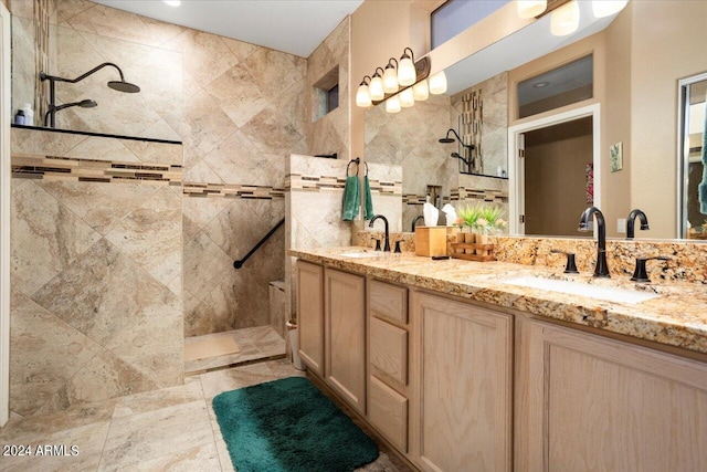 bathroom featuring a tile shower, tile walls, and vanity