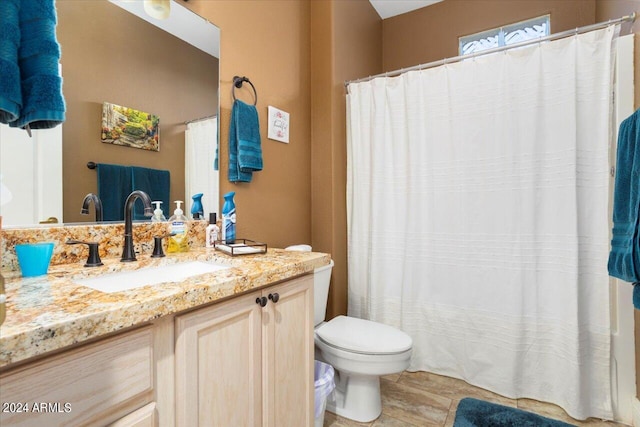 bathroom featuring vanity, toilet, tile patterned floors, and a shower with curtain