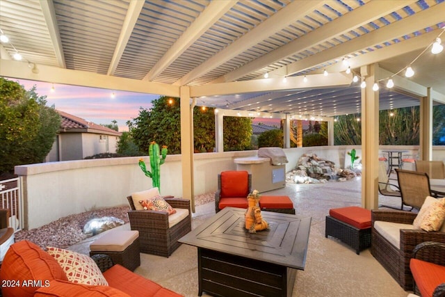 patio terrace at dusk featuring outdoor lounge area and a pergola