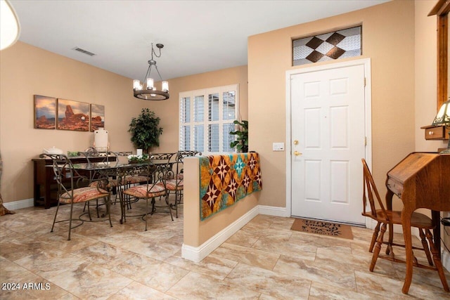 entryway featuring a notable chandelier