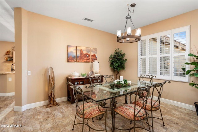 dining space featuring an inviting chandelier