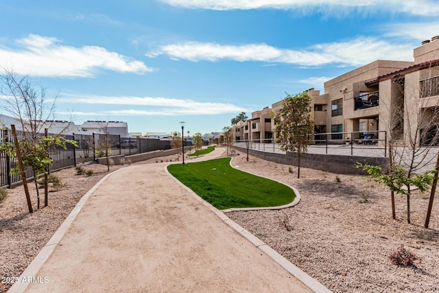 surrounding community with a residential view and fence