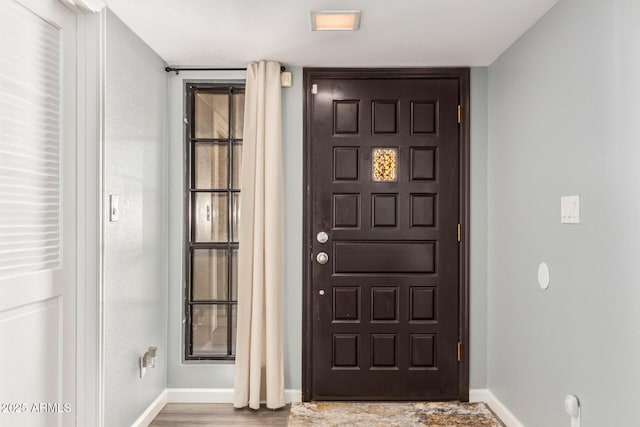 entryway featuring baseboards