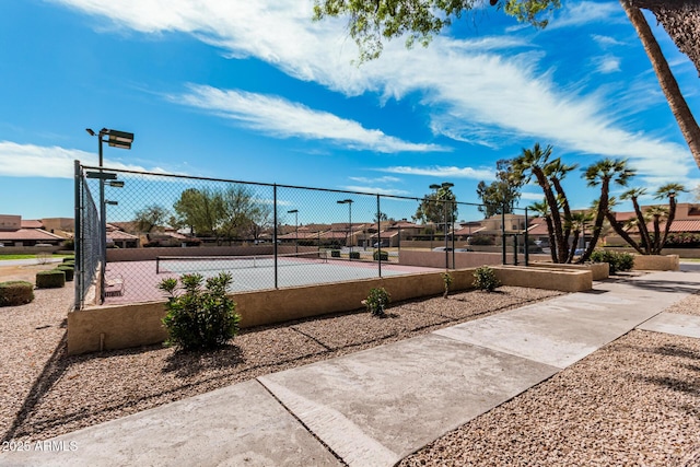 surrounding community featuring a tennis court, a residential view, and fence