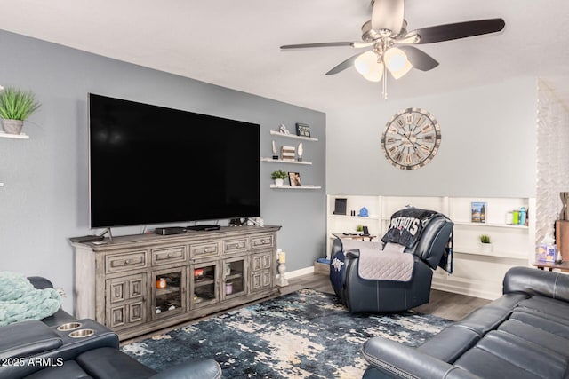 living room with ceiling fan, wood finished floors, and baseboards