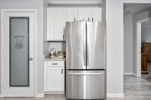 907 E Kelsi Ave, San Tan Valley, AZ 85140 - kitchen with freestanding refrigerator, baseboards, and white cabinetry