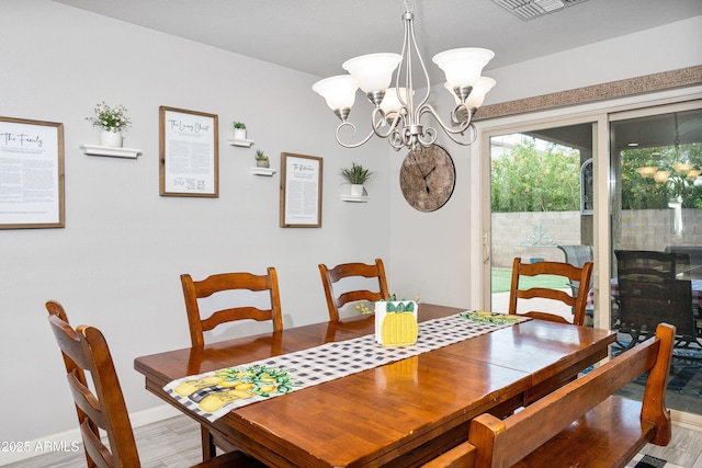 907 E Kelsi Ave, San Tan Valley, AZ 85140 - dining room featuring a chandelier, light wood finished floors, and baseboards