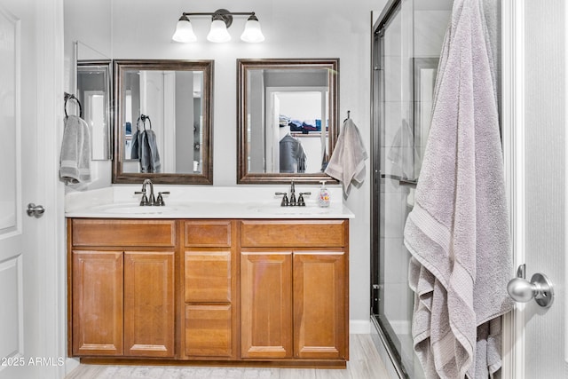 907 E Kelsi Ave, San Tan Valley, AZ 85140 - bathroom featuring a stall shower, double vanity, and wood finished floors