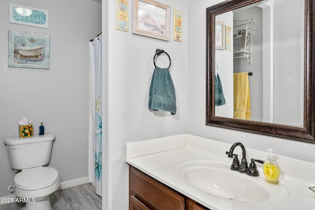 907 E Kelsi Ave, San Tan Valley, AZ 85140 - full bathroom featuring vanity, toilet, baseboards, and wood finished floors