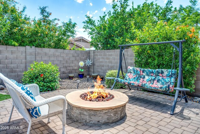 907 E Kelsi Ave, San Tan Valley, AZ 85140 - fenced backyard featuring an outdoor fire pit and a patio area