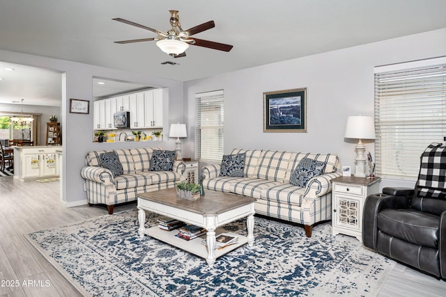907 E Kelsi Ave, San Tan Valley, AZ 85140 - living area featuring ceiling fan, light wood-style floors, a chandelier, baseboards, and recessed lighting