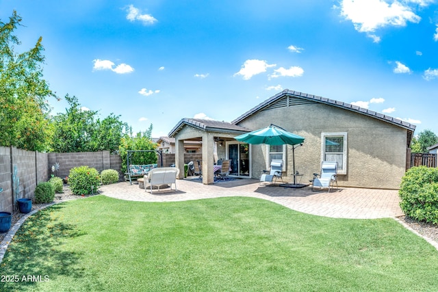 907 E Kelsi Ave, San Tan Valley, AZ 85140 - rear view of house with stucco siding and a patio