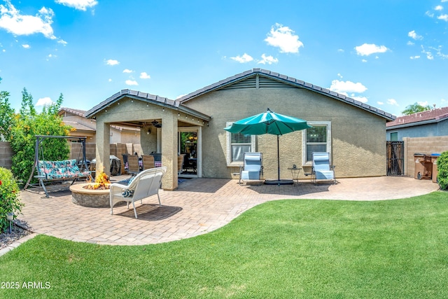 907 E Kelsi Ave, San Tan Valley, AZ 85140 - rear view of property featuring a fire pit, a ceiling fan, stucco siding, a patio area, and a gate