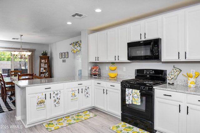 907 E Kelsi Ave, San Tan Valley, AZ 85140 - kitchen featuring black appliances, a peninsula, a chandelier, white cabinetry, and recessed lighting