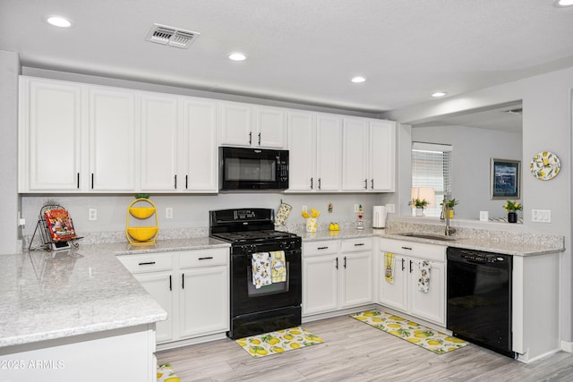 907 E Kelsi Ave, San Tan Valley, AZ 85140 - kitchen featuring black appliances, white cabinets, light wood-type flooring, and recessed lighting