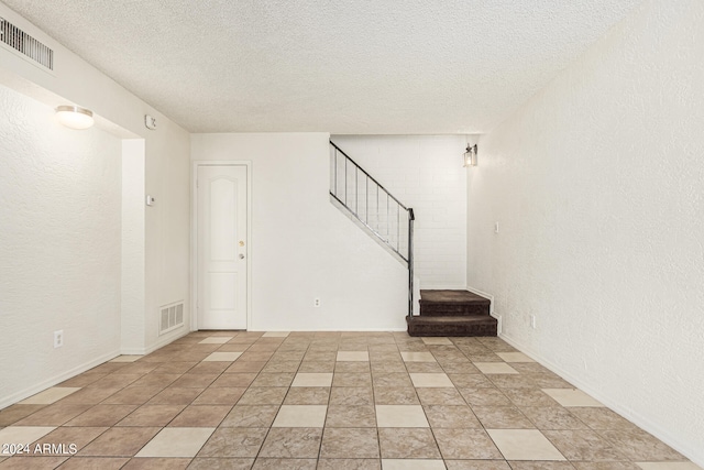 interior space with a textured ceiling