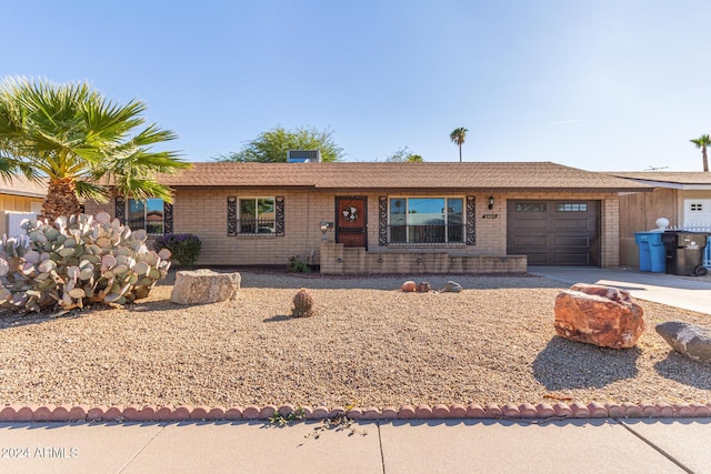 ranch-style home featuring a garage