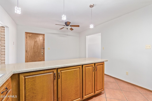 kitchen with hanging light fixtures, light tile patterned floors, and kitchen peninsula