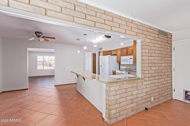 kitchen with sink, white appliances, hanging light fixtures, light tile patterned floors, and ceiling fan