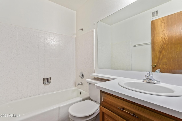 full bathroom featuring vanity, tiled shower / bath, and toilet