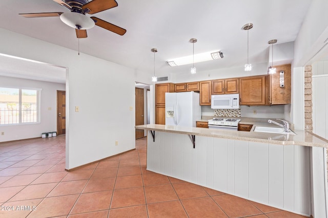 kitchen featuring white appliances, kitchen peninsula, hanging light fixtures, and light tile patterned floors